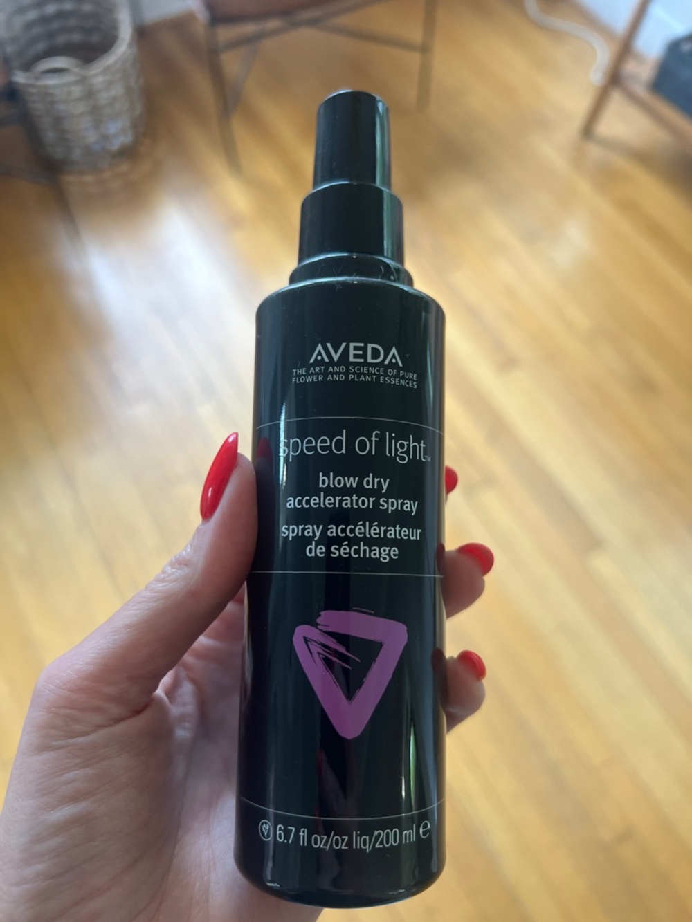 AVEDA black bottle with pink graphic blow dry accelerator spray